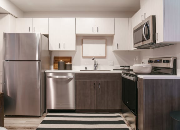 a kitchen with stainless steel appliances and white cabinets