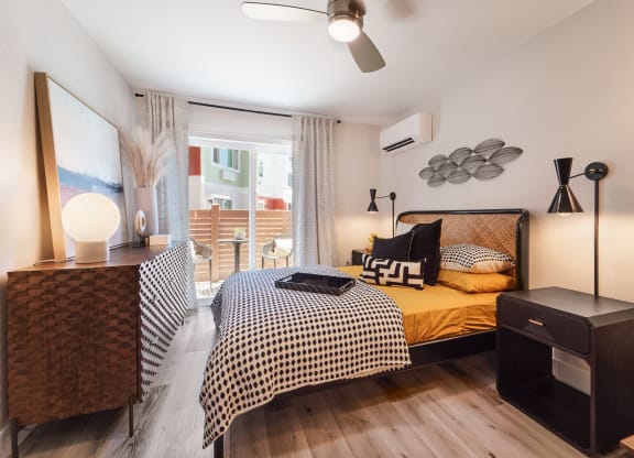 a bedroom with a bed and a large window