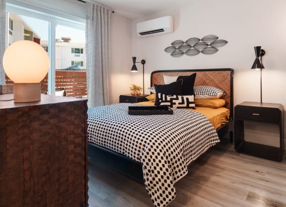 a bedroom with a bed and a ceiling fan