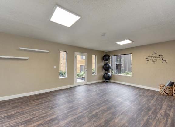 Community Yoga Studio with Hardwood Inspired Floor, Yoga Balls, Large Window and Wicker Basket with Yoga Mats at Fountains of Fair Oaks, Fair Oaks, CA 95628