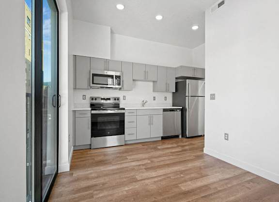a kitchen with white cabinets and stainless steel appliances