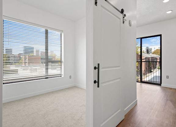 a large white door in a room with a large window