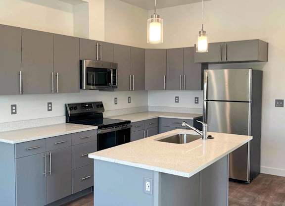 a kitchen with stainless steel appliances and a counter top