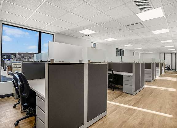 A long hallway with cubicles on both sides.