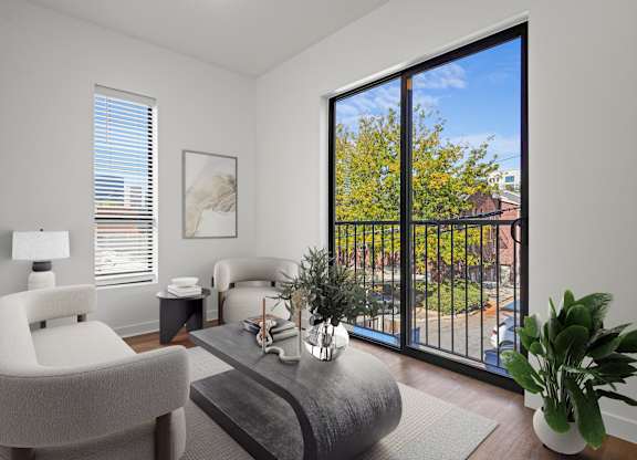 a living room with a large window and a balcony