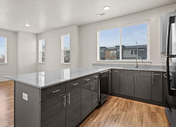 A kitchen with a large island and stainless steel appliances.