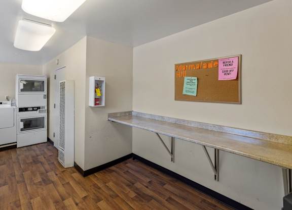 A kitchen with a white fridge and a white oven.