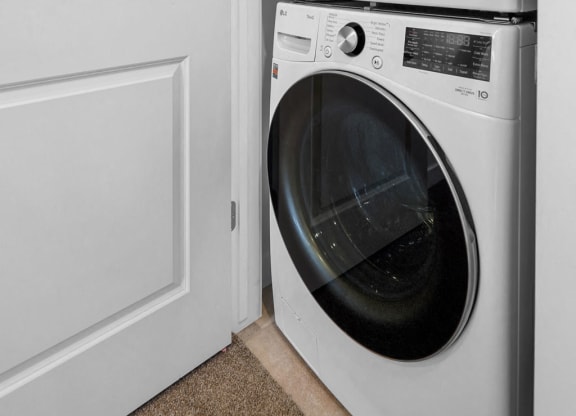 a white washer and dryer in a white laundry room