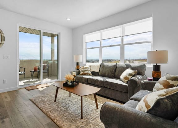 a living room with a couch and a table     and a balcony