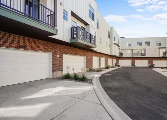 an empty parking lot in front of an apartment building