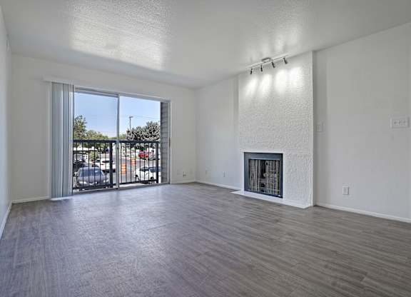 A spacious living room with a fireplace and sliding glass doors.