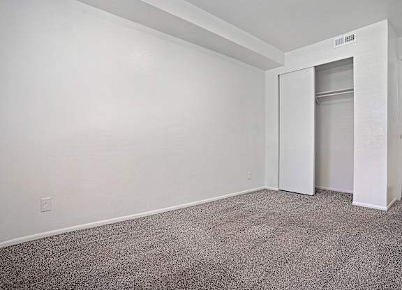 A room with a carpeted floor and white walls.