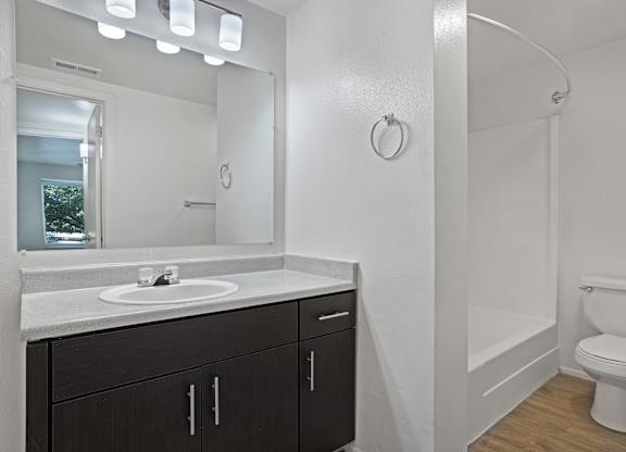 A bathroom with a white toilet and a white sink.