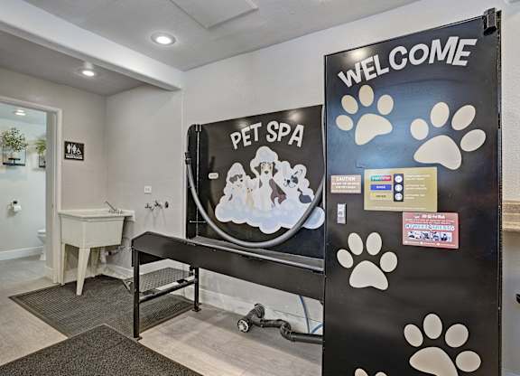 A pet spa with a sign that says "Welcome" and a picture of a dog and cat.