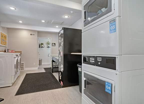 A laundry room with a washer and dryer stacked on top of each other.