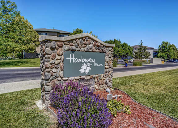 A stone sign that says Hanbury in front of a building.