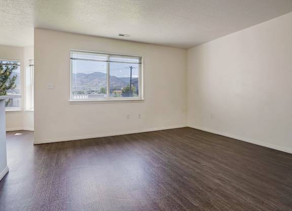 Empty room with a window overlooking the street.