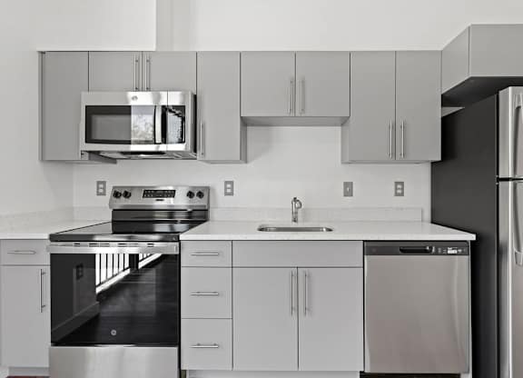 a kitchen with stainless steel appliances and white cabinets