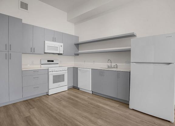 A kitchen with white appliances and cabinets.