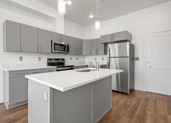 a kitchen with stainless steel appliances and a white counter top