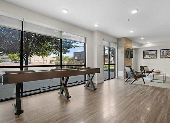 a living room with a piano and a large window