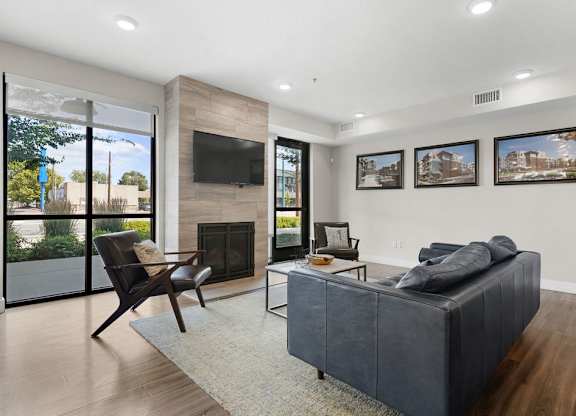the living room has a fireplace and a leather couch
