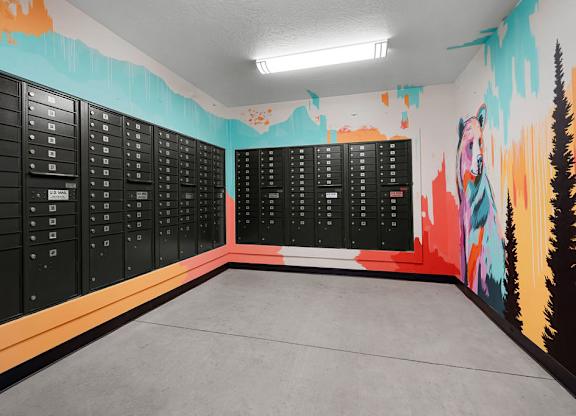 a locker room with a wall mural of mountains and trees