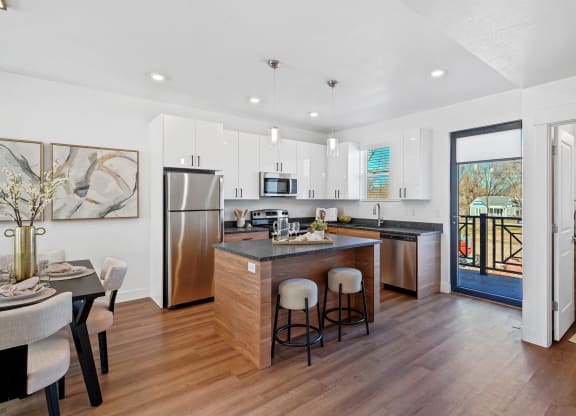 Open kitchen with stainless steel refrigerator at Current by Lotus, Ogden, UT, 84401