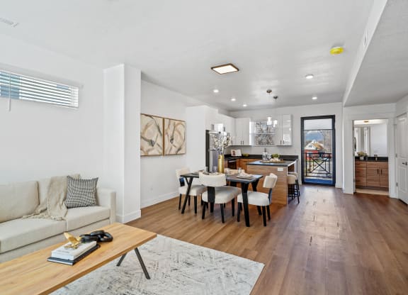 a living room with a couch and a table with chairs at Current by Lotus, Ogden, 84401