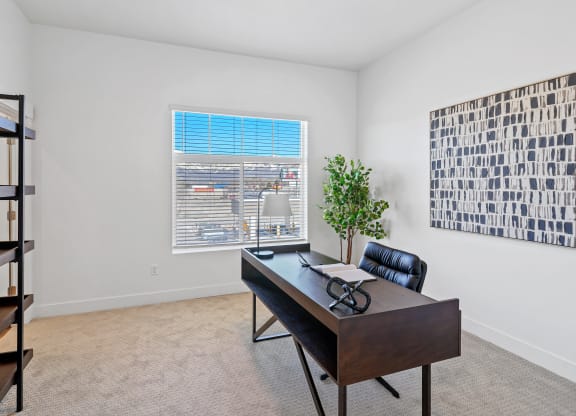 an office with a large window and a desk with a leather chair at Current by Lotus, Utah , 84401