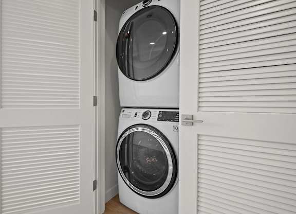 a small laundry room with a washing machine and a dryer at SPARK Apartments, Salt Lake CIty