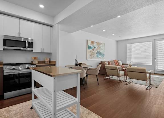 a living room with a kitchen and a dining room