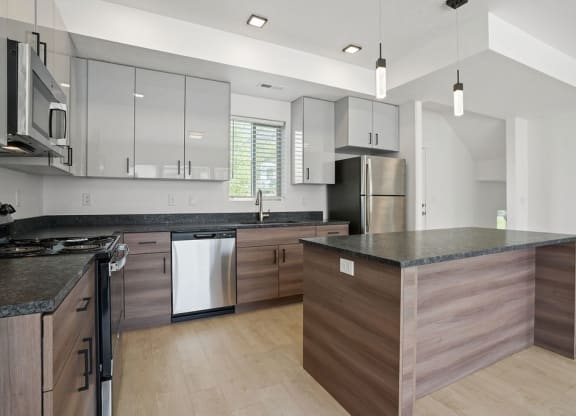 a large kitchen with an island and stainless steel appliances