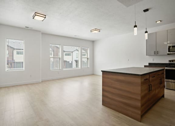 an empty kitchen with a large island in the middle of it