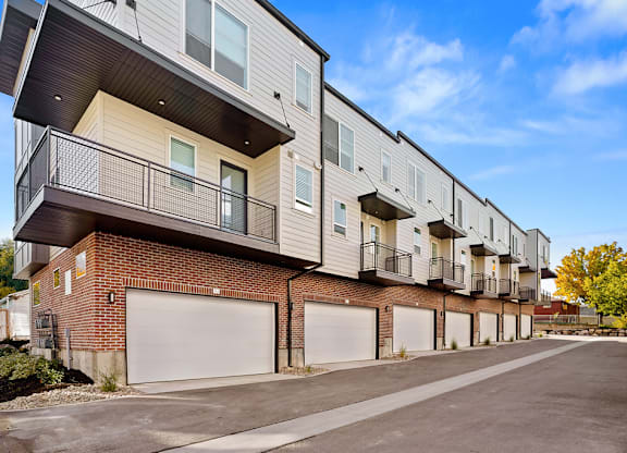 the exterior of an apartment building with white doors