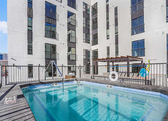 A swimming pool on a balcony of a building.