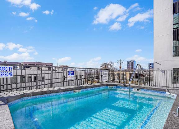 A pool with a slide and a sign that says capacity persons.