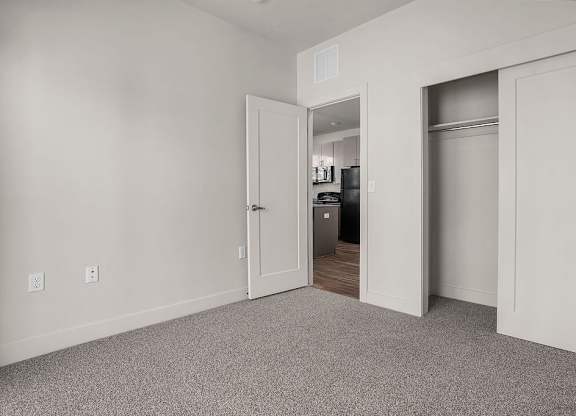 A room with a white door and a white wall.