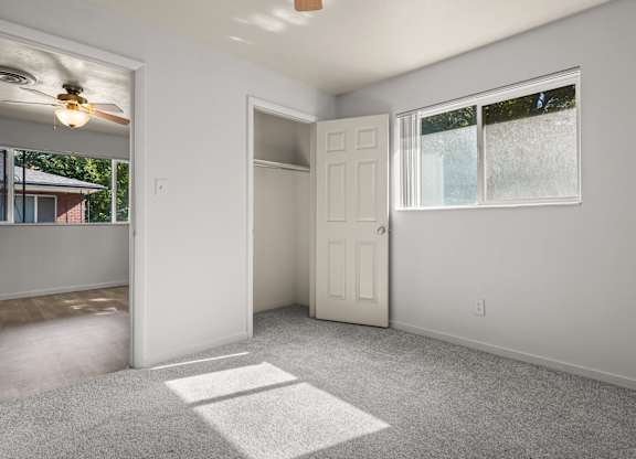 A room with a white door and a window with a white frame.