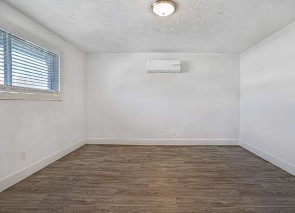 A room with a window and a ceiling light.