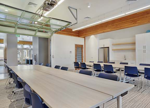A conference room with a long table and chairs.