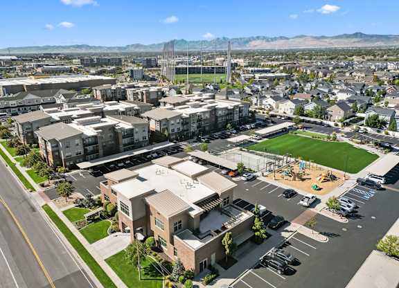 an aerial view of a city with buildings and a soccer field