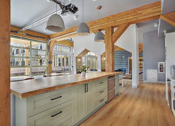 A kitchen with wooden cabinets and a large island.
