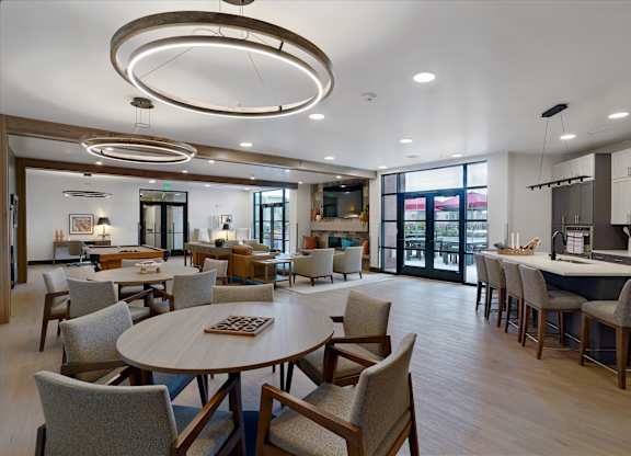 A modern dining room with a large table and chairs.