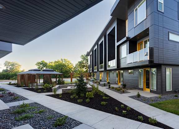 A modern building with a walkway in front of it.