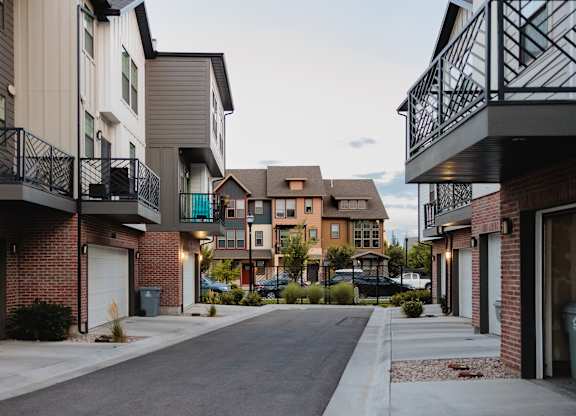 A row of modern townhouses with garages and balconies.