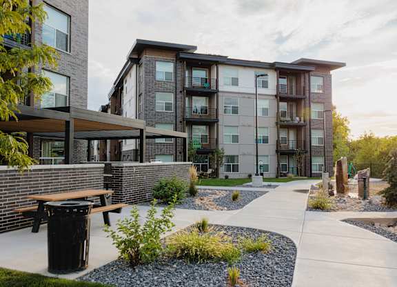 A modern apartment complex with a landscaped courtyard.