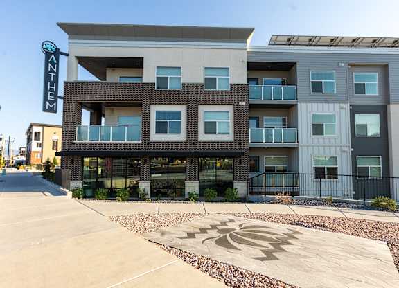 A modern building with a sign that reads "ANTHEM" in front of it.