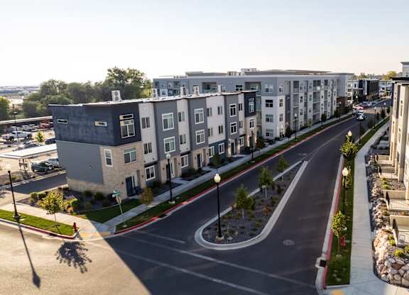 A street view of a residential area with modern apartment buildings.