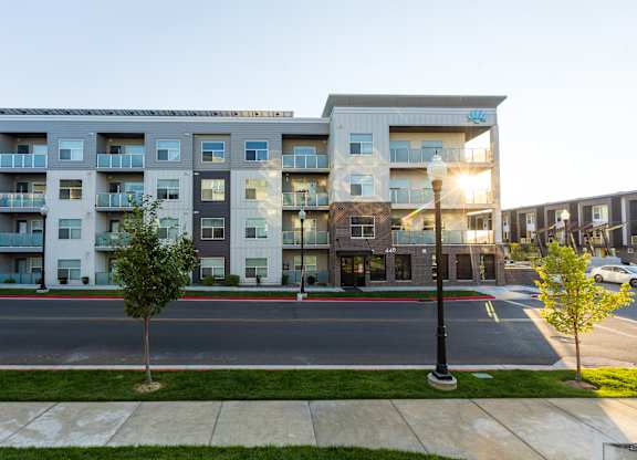 A modern apartment building with a street in front.